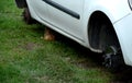 Repair of a red white car and spraying black chassis against rust. the car is sealed with tape and foil. the car painter also disa