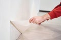 Repair and renovate the interior of the house with their own hands. Close-up of the moment of tearing the old wallpaper off the Royalty Free Stock Photo