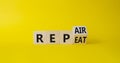 Repair and Repeat symbol. Turned wooden cubes with words Repeat and Repair. Beautiful yellow background. Business and Repair and