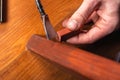 Repair and restoration of wooden furniture. master closes a scratch on the table leg