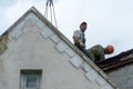 Repair of the roof of a beautiful old building in the city center. High-altitude work involves a risk to life. Workers are Royalty Free Stock Photo