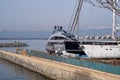 Repair of sea yachts and ships in a European port on mountains background