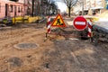 repair of sidewalks and roads in the city. A section of the street closed from traffic. A road sign signifying a dangerous zone