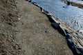 Repair of the slope above the river, the river banks are strengthened by a bunch of stonemasons where the embankment is paved with Royalty Free Stock Photo