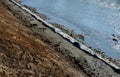 Repair of the slope above the river, the river banks are strengthened by a bunch of stonemasons where the embankment is paved with Royalty Free Stock Photo