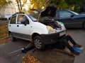 Repair of a small old car in the city yard Royalty Free Stock Photo