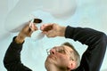 Repair of spot ceiling lamp built into false ceiling. Royalty Free Stock Photo