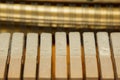 Repair of a stringed musical instrument. Inside view of a piano with brass metal strings and a wooden mallet. A musical
