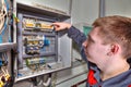 Repair of switchboard, engineer electrician inspects the fuse bo