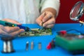 Repair of the video converter board of the TV signal. Soldering of electronic components by an engineer of modern TVs.