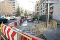 Repair work on a city center sidewalk due to a broken water pipe diverting traffic.