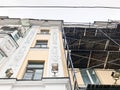 Repair work on the facade of the building with the help of wooden scaffolding, structures, restoration of the old house Royalty Free Stock Photo