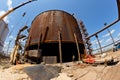Repair work on replacement of lower belts of old rusty tank for Royalty Free Stock Photo