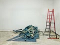 Repair works in the office, a bunch of stripped carpet on the floor and a ladder, workflow Royalty Free Stock Photo