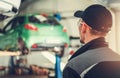 Repair workshop with cars hoisted on hydraulic lift Royalty Free Stock Photo