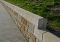 Repaired renovated sandstone walls near the cemetery. stairs and railings of the wall made of new stone which weatheres quickly bu Royalty Free Stock Photo