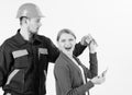 Repairer get salary for work. Expensive service concept. Woman client pay to man in helmet, Royalty Free Stock Photo