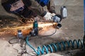 Mechanic cuts new pipe for corrugation silence