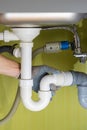 Repairing a drain pipe in the kitchen under the sink Royalty Free Stock Photo