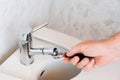 Repairing a faucet in a bathroom Royalty Free Stock Photo