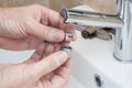 Repairing a faucet in a bathroom Royalty Free Stock Photo