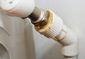 Repairing, fixing a leaking radiator valve of a central heating radiator. A leaking heating radiator because of a bad plumberÃ¢â¬â¢s Royalty Free Stock Photo