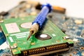 Repairing inside of hard disk by soldering iron. Integrated Circuit. the concept of data, hardware, technician