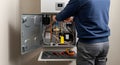 repairing a modern boiler system in a home setting Royalty Free Stock Photo