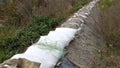 Repairing old sandbags flood protection