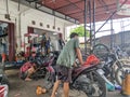 repairing a puple motorcycle in a motorcycle workshop