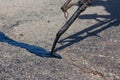 repairing the road, pour small cracks with bitumen