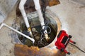Repairing a sump pump in a basement Royalty Free Stock Photo
