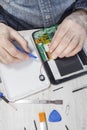 Repairing the tablet on the website. Opening the tablet by an employee.