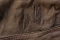 Repairing torn black jeans. black jeans surface has holes and threads, stitches from repairs. Denim blue jeans, Close up Macro. Royalty Free Stock Photo