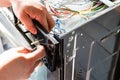 Repairman assembles electric stove during repair