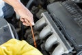 Repairman auto mechanic check engine oil condition. man worker service engine mechanic garage. Transportation repair service