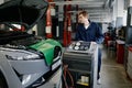 Repairman at car garage doing air conditioner or climate control servicing Royalty Free Stock Photo