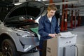 Repairman at car garage doing air conditioner or climate control servicing Royalty Free Stock Photo