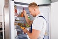 Repairman Checking Refrigerator