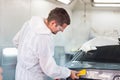 Repairman checking shades cards for car painting, Worker painter checking color matching before painting, Garage painting car