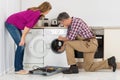 Repairman Checking Washing Machine