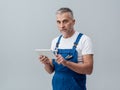 Repairman connecting with a tablet Royalty Free Stock Photo