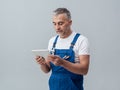 Repairman connecting with a tablet Royalty Free Stock Photo
