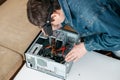 Repairman is disassembling personal computer. Engineer is diagnostic and fixing broken pc in workshop.