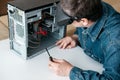 Repairman is disassembling personal computer. Engineer is diagnostic and fixing broken pc in workshop. Royalty Free Stock Photo