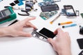 Repairman disassembling phone for inspecting Royalty Free Stock Photo