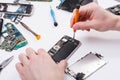 Repairman disassembling phone with screwdriver