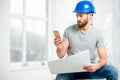 Repairman with drawings in the apartment Royalty Free Stock Photo