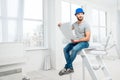 Repairman with drawings in the apartment Royalty Free Stock Photo