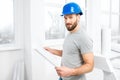 Repairman with drawings in the apartment Royalty Free Stock Photo